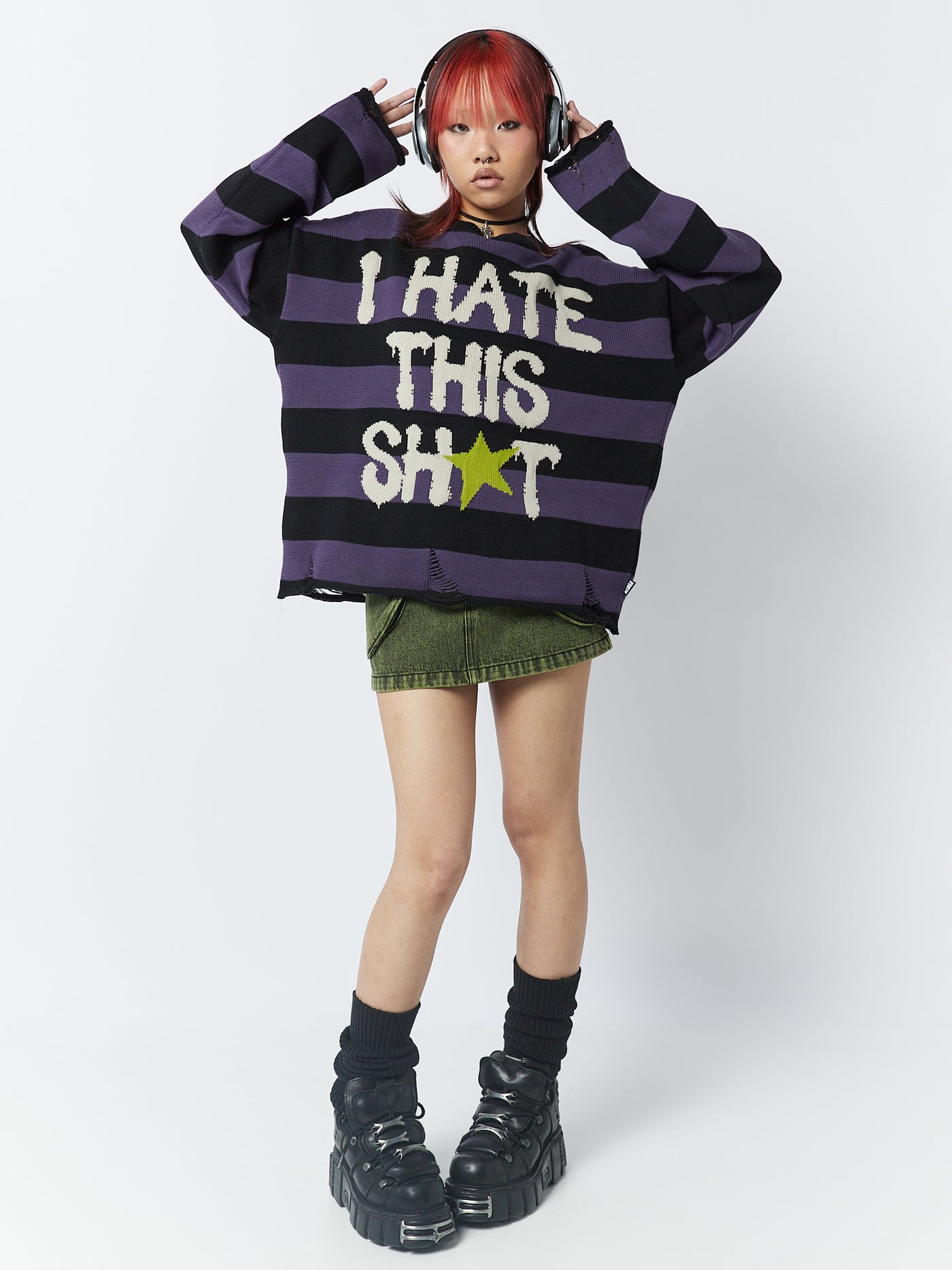 A striped jumper with the graphic "I Hate This Sh*t" by Minga London. This jumper combines a bold and rebellious design with trendy stripes, making a statement and adding a touch of attitude to your outfit.