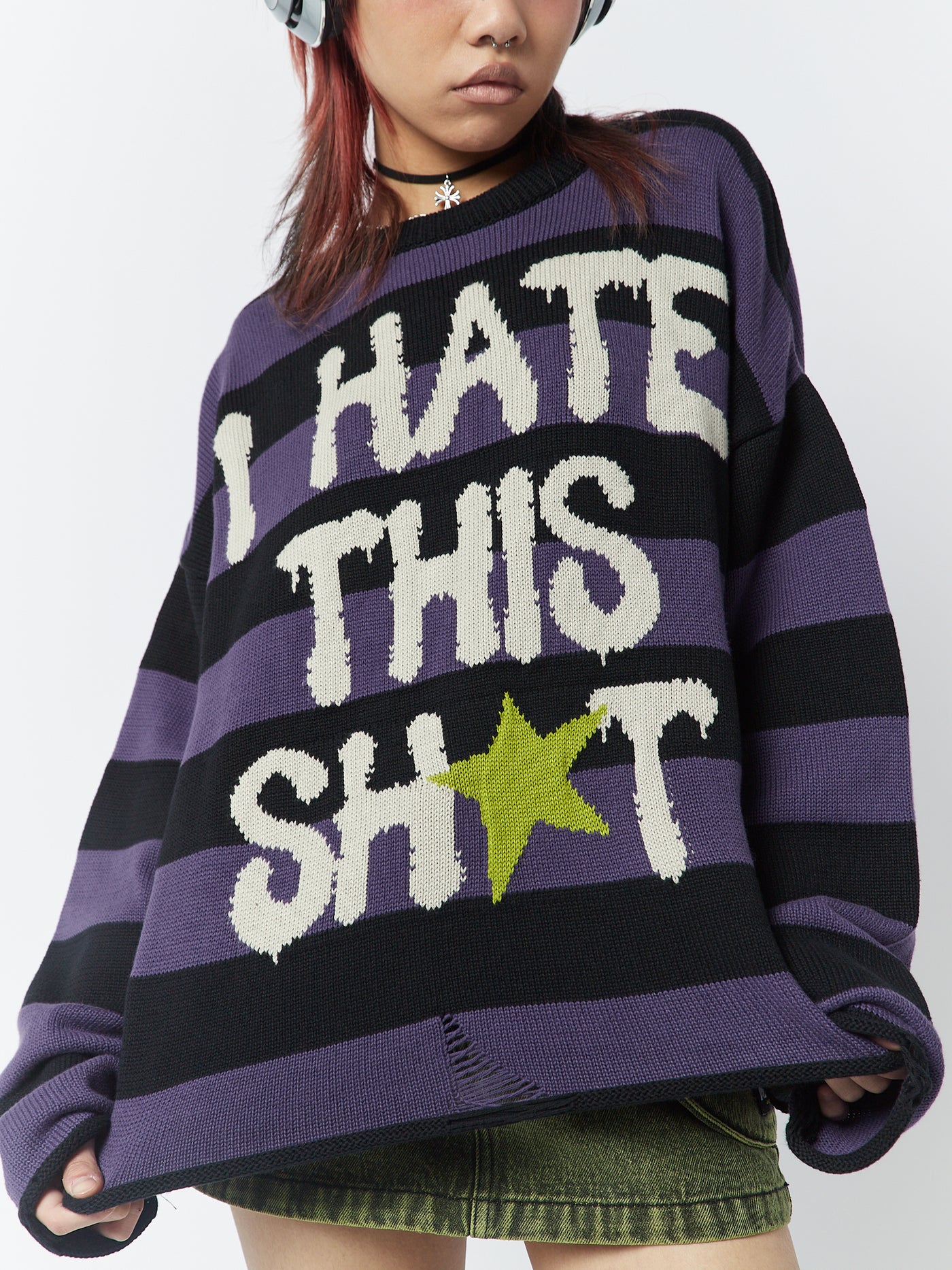 A striped jumper with the graphic "I Hate This Sh*t" by Minga London. This jumper combines a bold and rebellious design with trendy stripes, making a statement and adding a touch of attitude to your outfit.