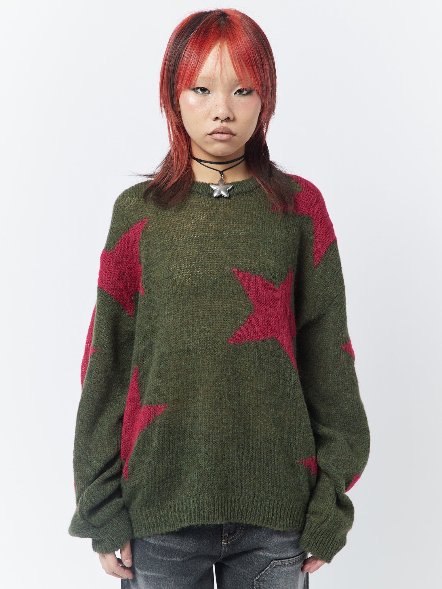 Pink and khaki knit sweater with stars design, perfect for a cozy and stylish look.
