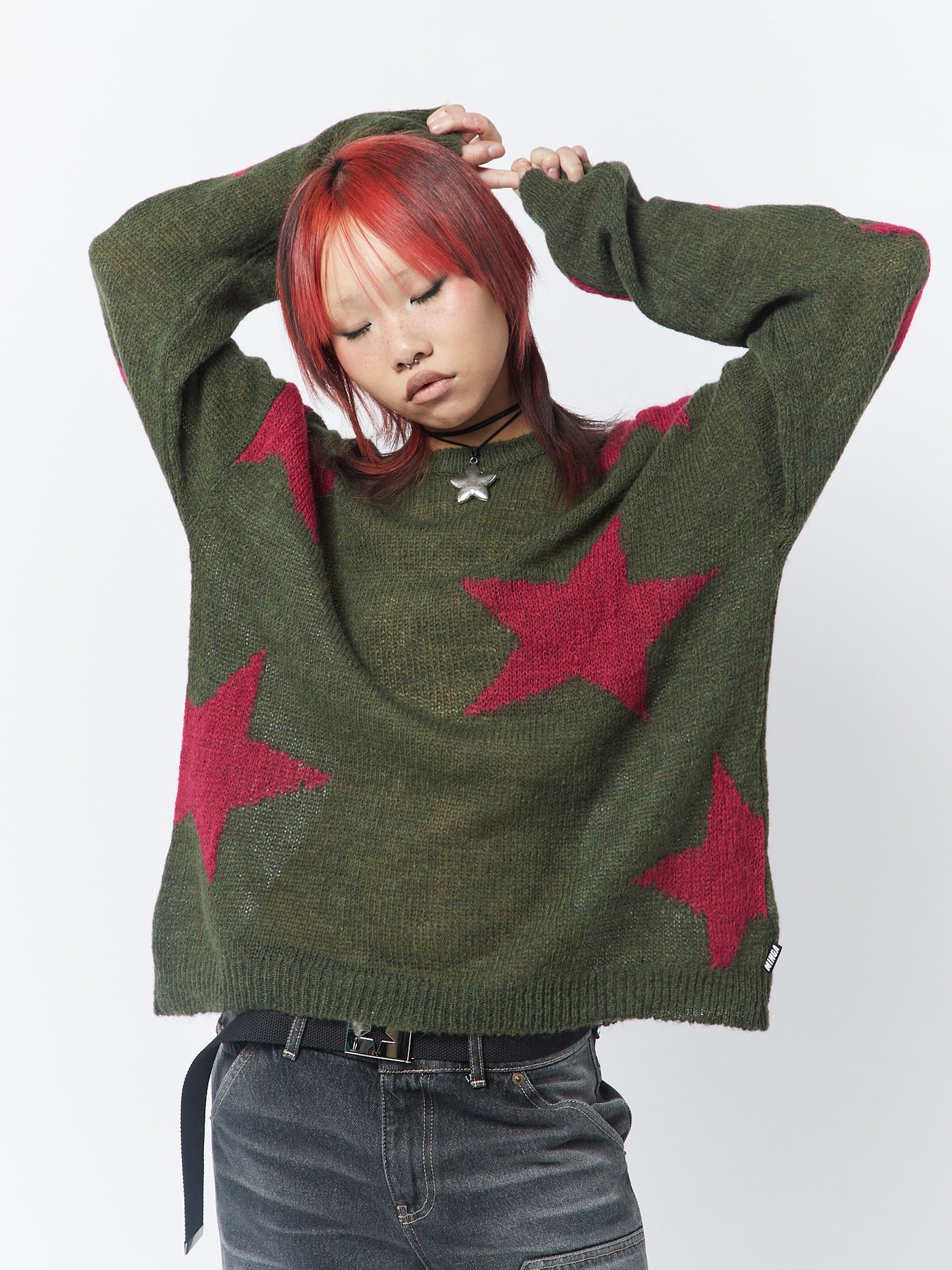 Pink and khaki knit sweater with stars design, perfect for a cozy and stylish look.