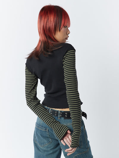 A green and black striped long sleeve top by Minga London. Featuring a Star graphic, this top offers a trendy and stylish look with a touch of edginess.