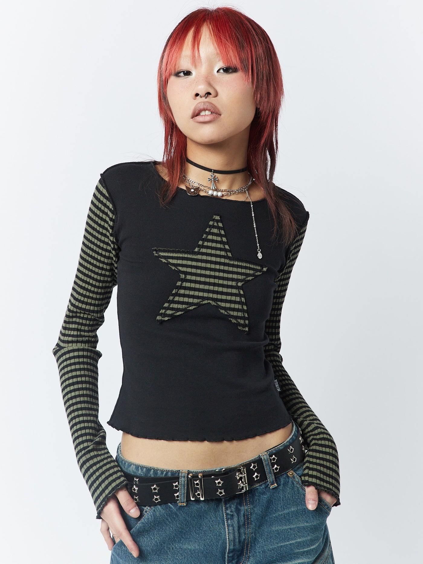 A green and black striped long sleeve top by Minga London. Featuring a Star graphic, this top offers a trendy and stylish look with a touch of edginess.