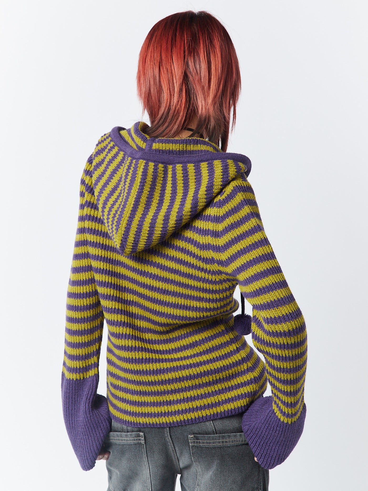 A knitted hoodie named Paige in a vibrant yellow and purple color combination by Minga London. This hoodie offers a cozy and stylish option, with its colorful knit and comfortable design perfect for adding a pop of color to your wardrobe.