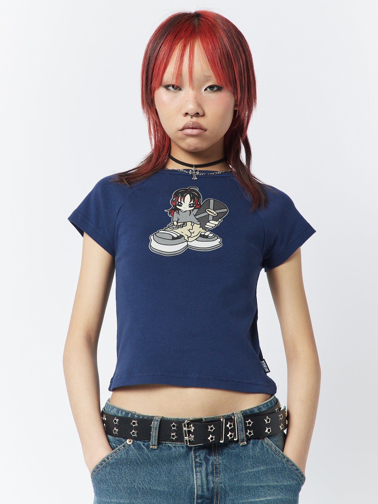  A blue baby tee with a skater girl graphic, showcasing a cool and playful design for an effortlessly stylish look.
