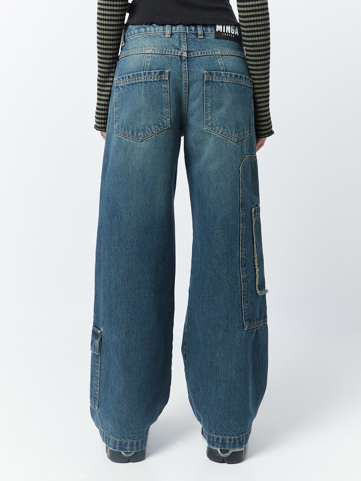Blue overdye cargo jeans named Track by Minga London. These jeans feature multiple pockets, combining style and functionality for a trendy and versatile look.