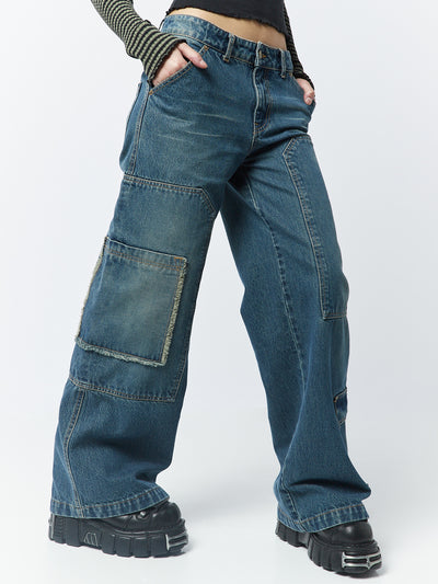 Blue overdye cargo jeans named Track by Minga London. These jeans feature multiple pockets, combining style and functionality for a trendy and versatile look.