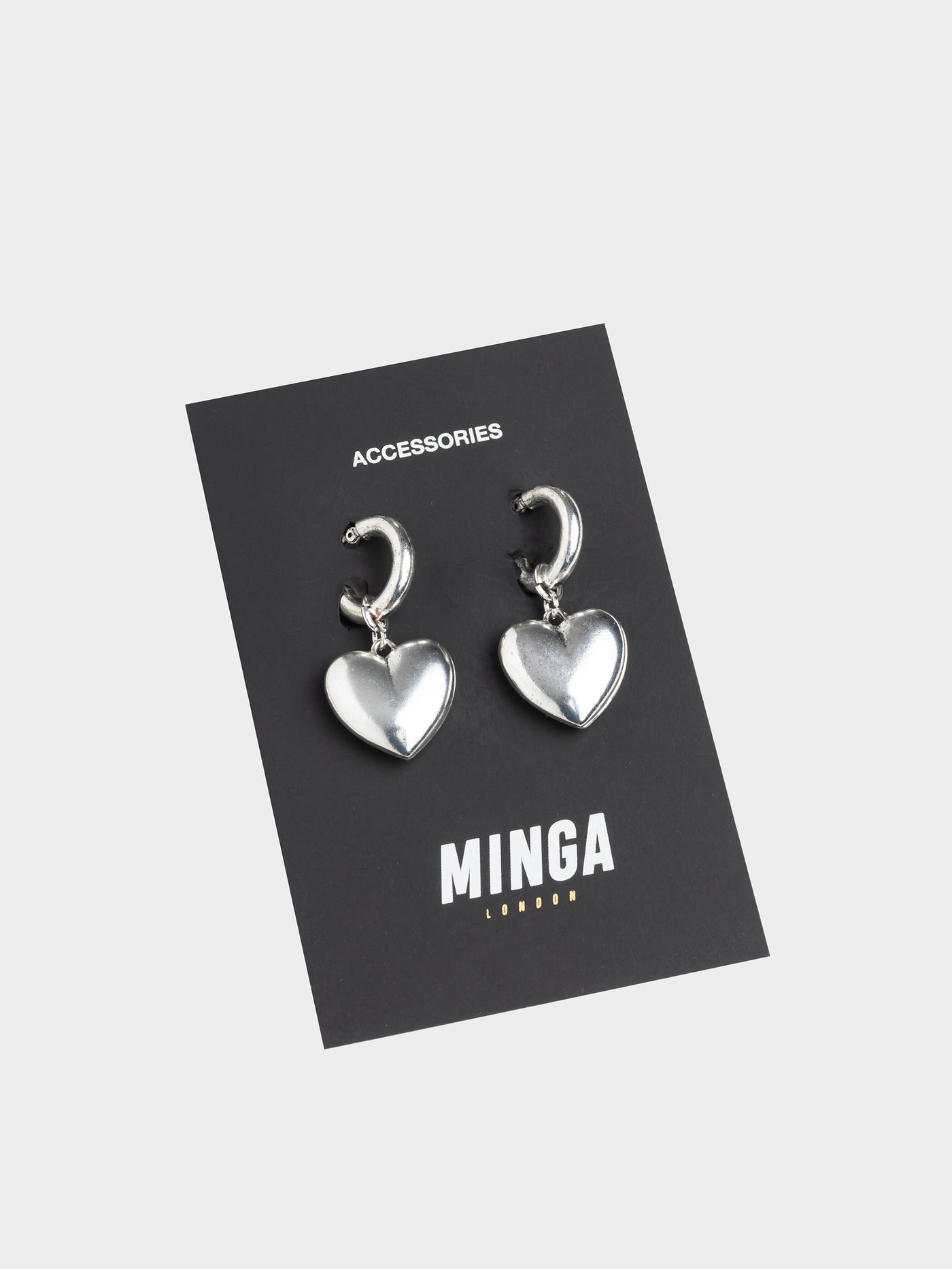 Stylish and statement-making earrings featuring chunky heart-shaped hoops for a bold and trendy look.