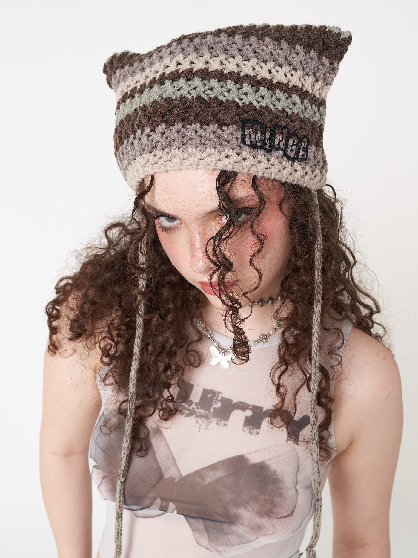 Knitted tie hat with all over stripes in green, brown and beige matching crochet style pattern 