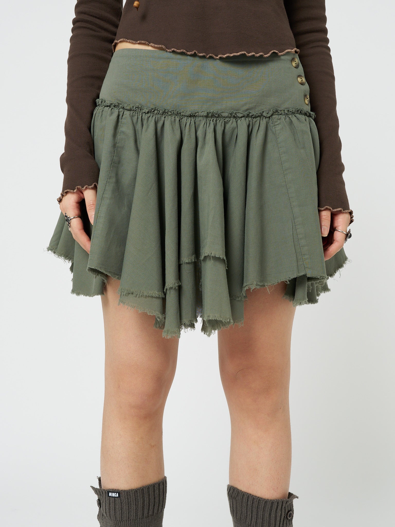 Embrace the whimsical allure of fairycore with this green layered asymmetrical mini skirt, perfect for adding a touch of enchantment to your outfit.