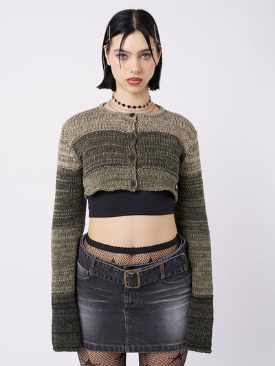 A green extreme cropped cardigan by Minga London. This cardigan features a bold and edgy design with an extremely cropped length. Perfect for adding a daring and unique touch to your outfit.