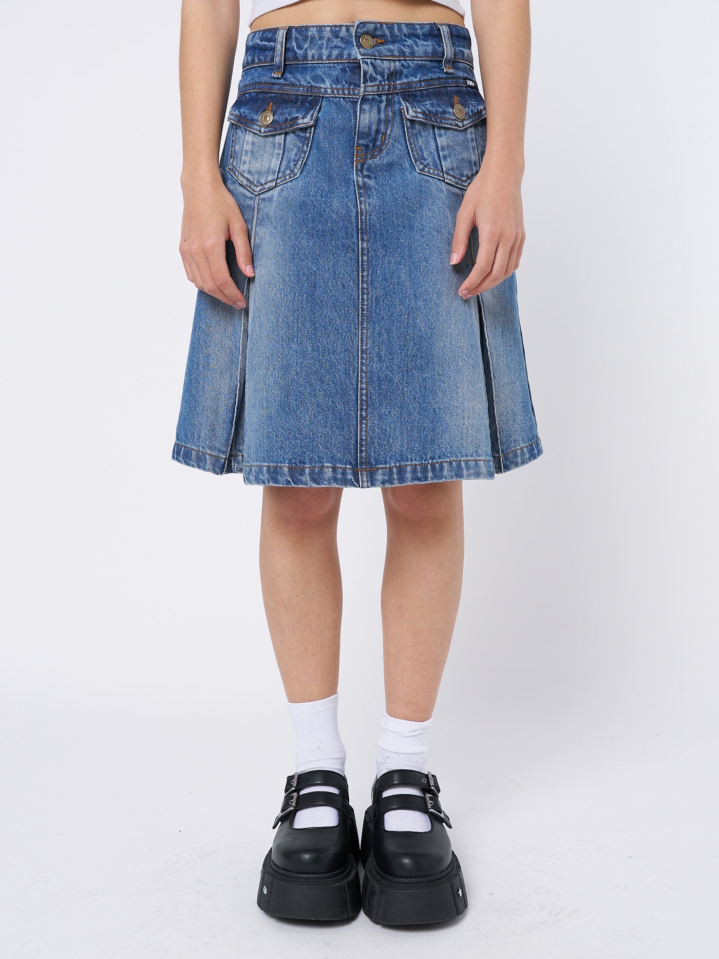  Denim pleated midi skirt by Minga London. Flared silhouette with a blue wash. Versatile and stylish for various occasions.