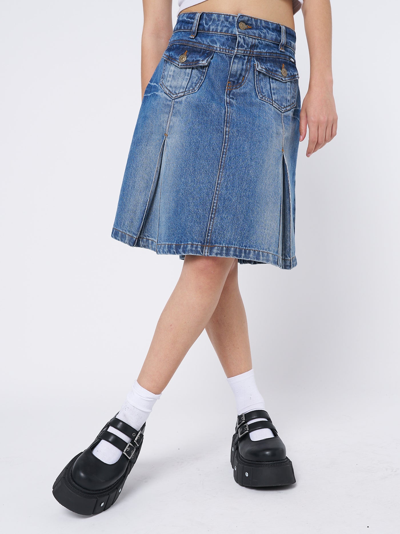  Denim pleated midi skirt by Minga London. Flared silhouette with a blue wash. Versatile and stylish for various occasions.