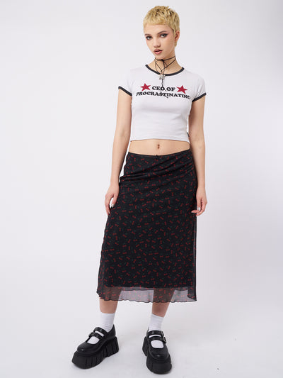 A mesh midi skirt with cherries print in black by Minga London. This skirt features a flirty and airy design, perfect for adding a playful and trendy touch to your outfit.