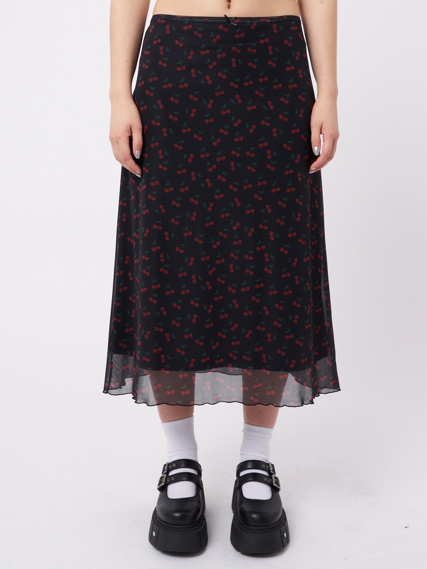 A mesh midi skirt with cherries print in black by Minga London. This skirt features a flirty and airy design, perfect for adding a playful and trendy touch to your outfit.