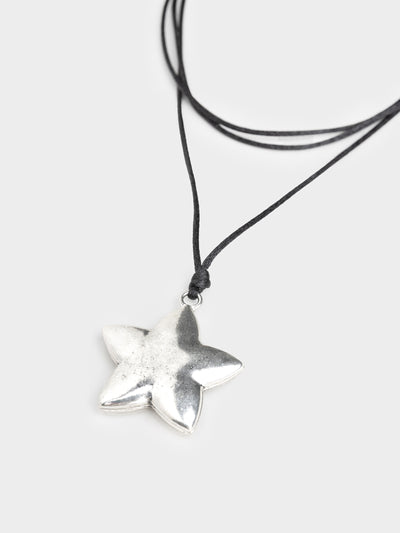 This chunky pendant necklace features a star design, adding a touch of celestial charm to your look. The bold and eye-catching pendant hangs from a sturdy chain, making it a stylish statement accessory for any outfit.