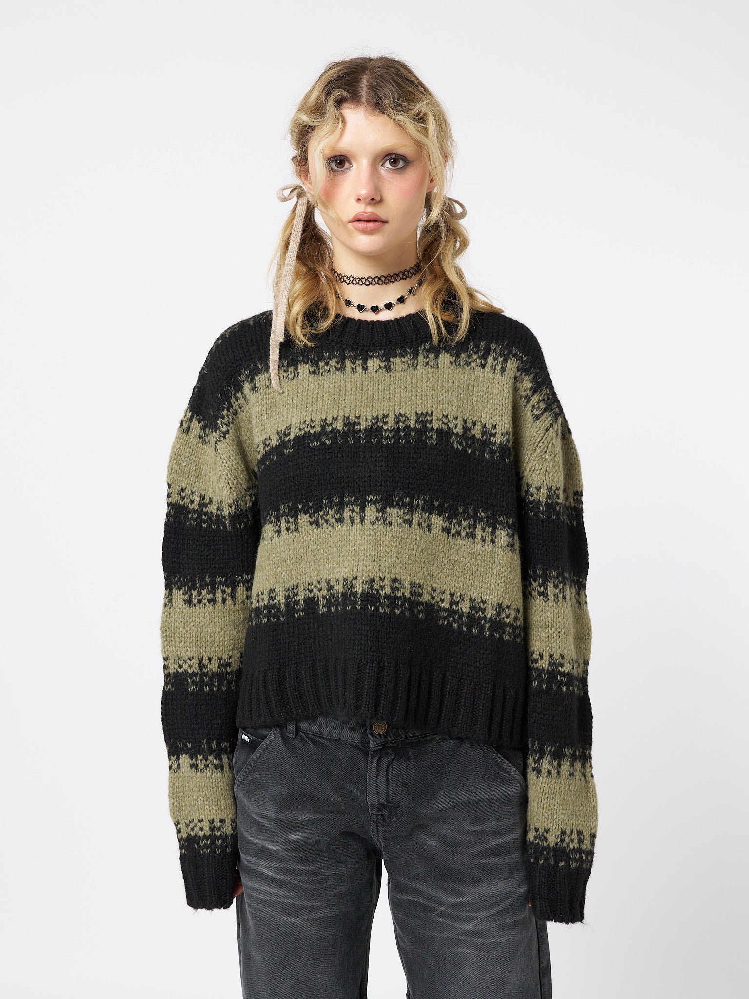  A trendy and stylish green and black striped cropped knit sweater.