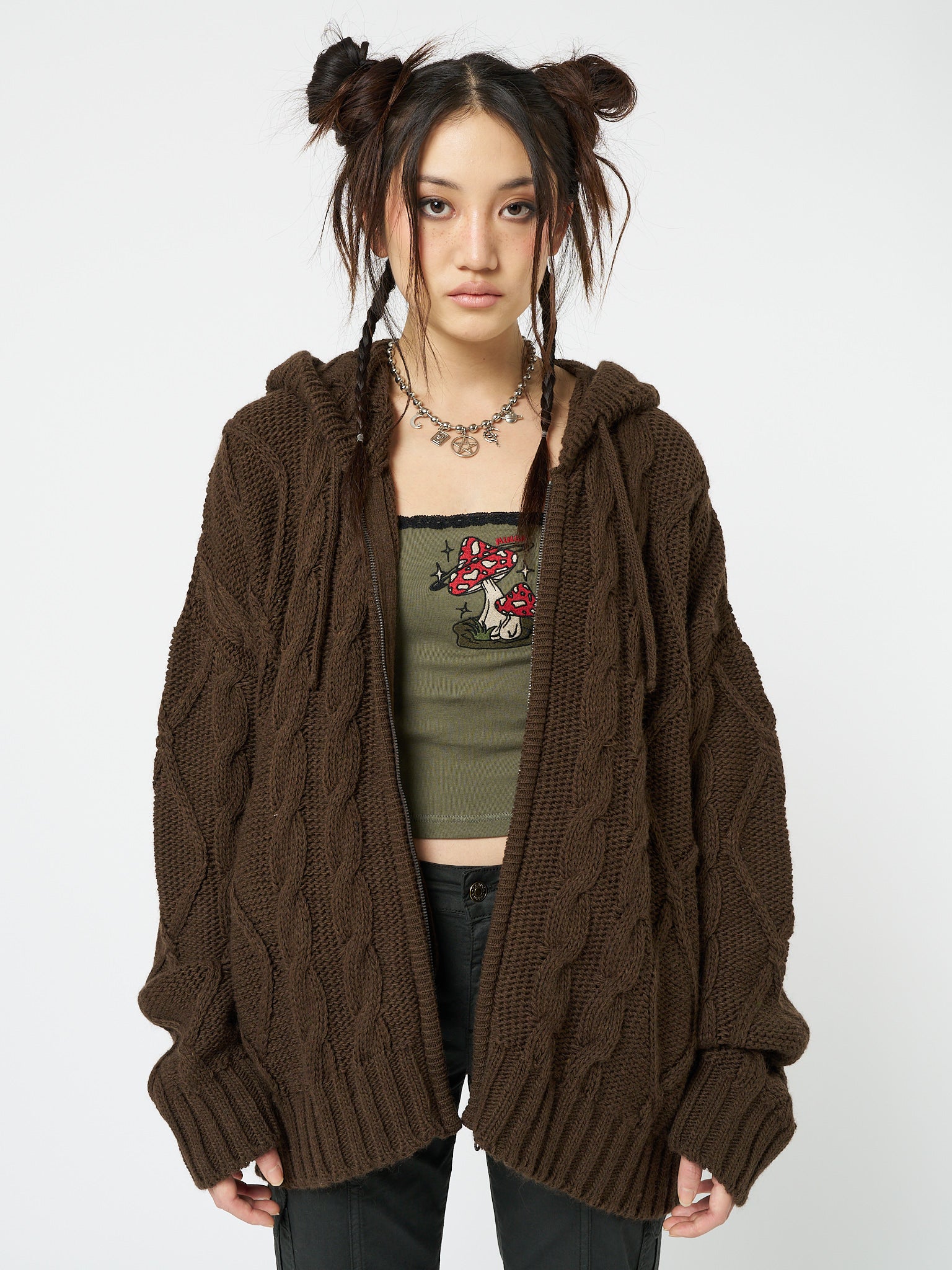 Brown cable knit cardigan named Eli by Minga London, featuring a cozy and stylish zip-up design for a fashionable and comfortable layering piece.