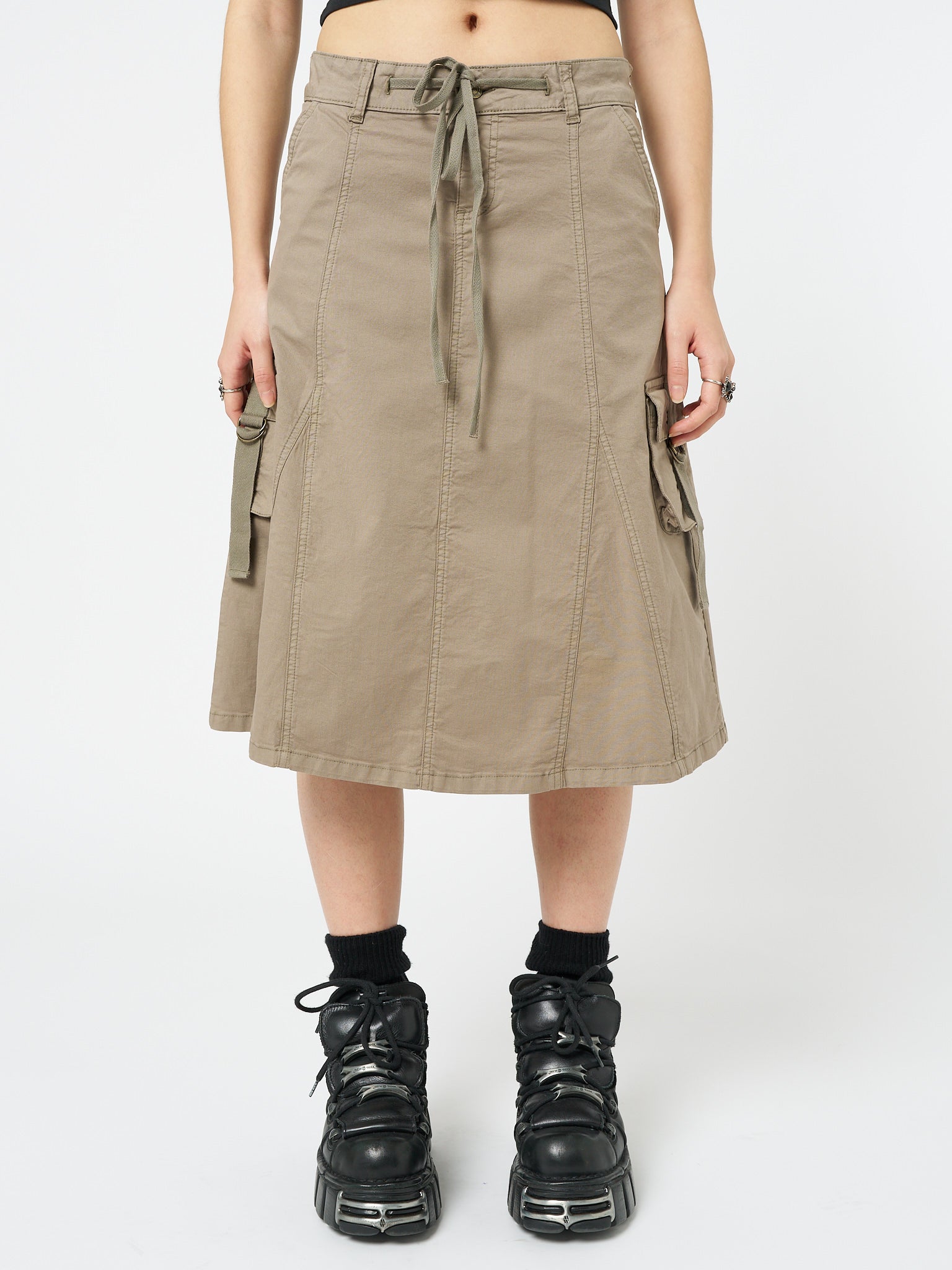 Brown cargo midi skirt named Fae by Minga London, offering a stylish and versatile option with its utilitarian-inspired design and neutral beige color.