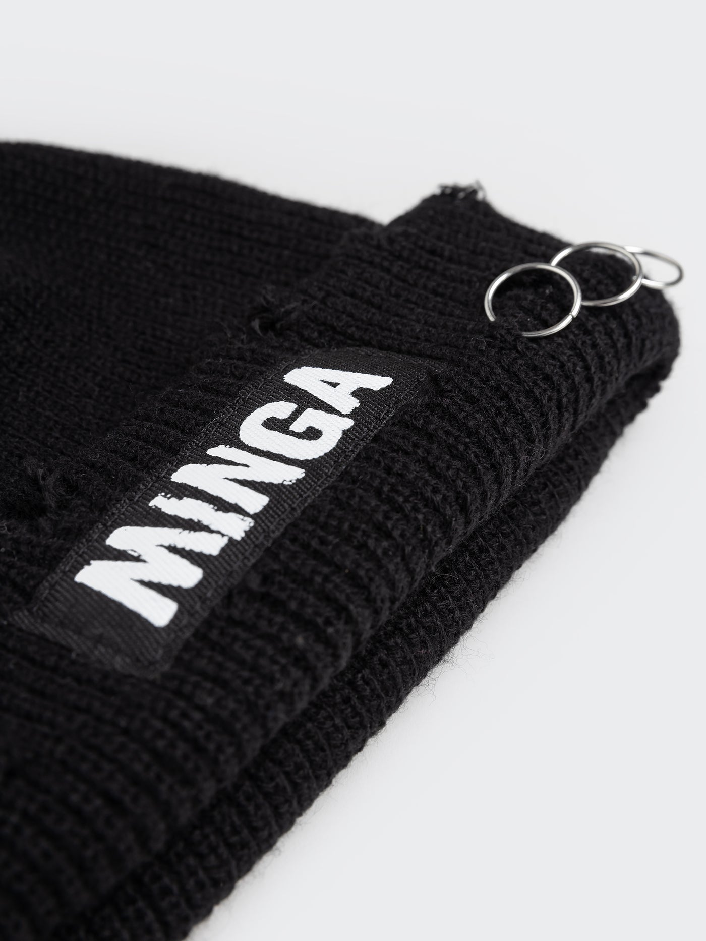A stylish and edgy black beanie with distressed details for a rugged and trendy look.