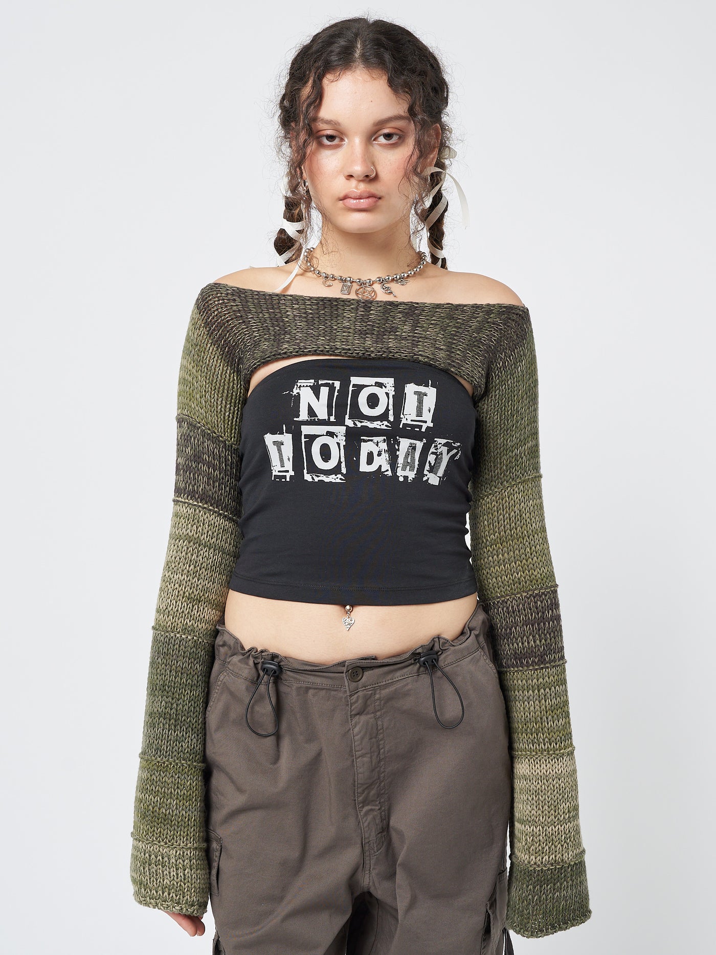  A unique and vibrant knitted shrug with a patchwork design in various shades of green.