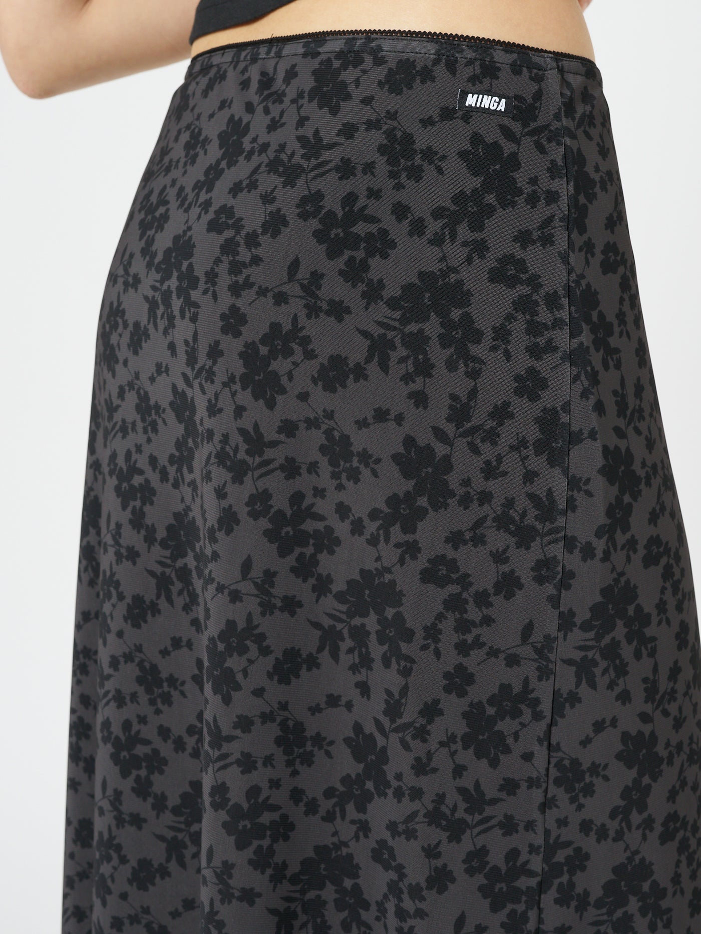 This charming skirt features a captivating floral pattern, flowing silhouette, and a flattering midi length for a enchanting look.