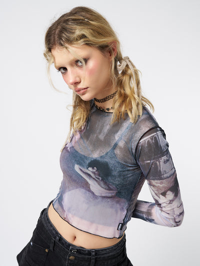  A captivating long sleeve mesh top with an enchanting graphic design.