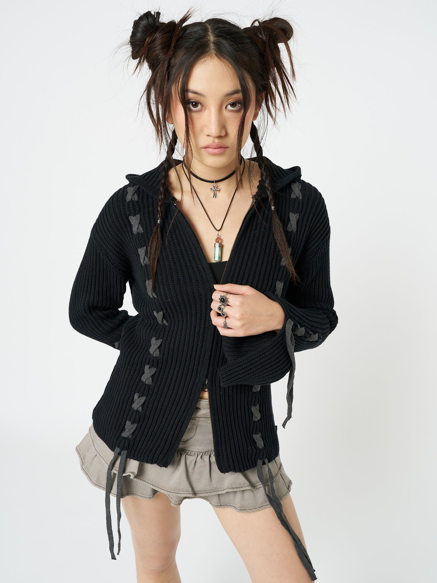 This black lace-up hoodie cardigan combines comfort and style effortlessly. The lace-up detailing adds a trendy touch to the classic hoodie design, making it a versatile and fashionable piece for any casual outfit.