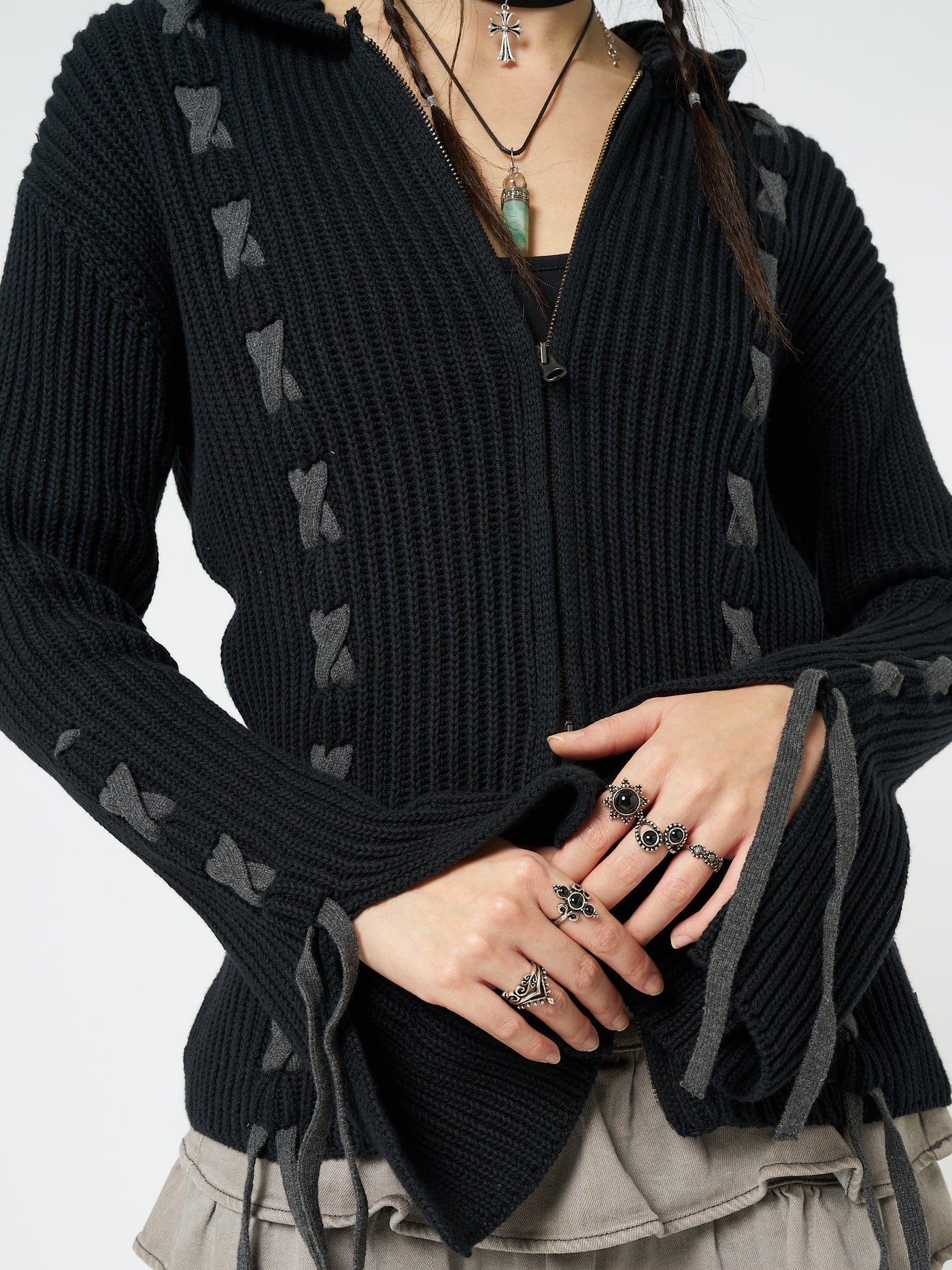 This black lace-up hoodie cardigan combines comfort and style effortlessly. The lace-up detailing adds a trendy touch to the classic hoodie design, making it a versatile and fashionable piece for any casual outfit.