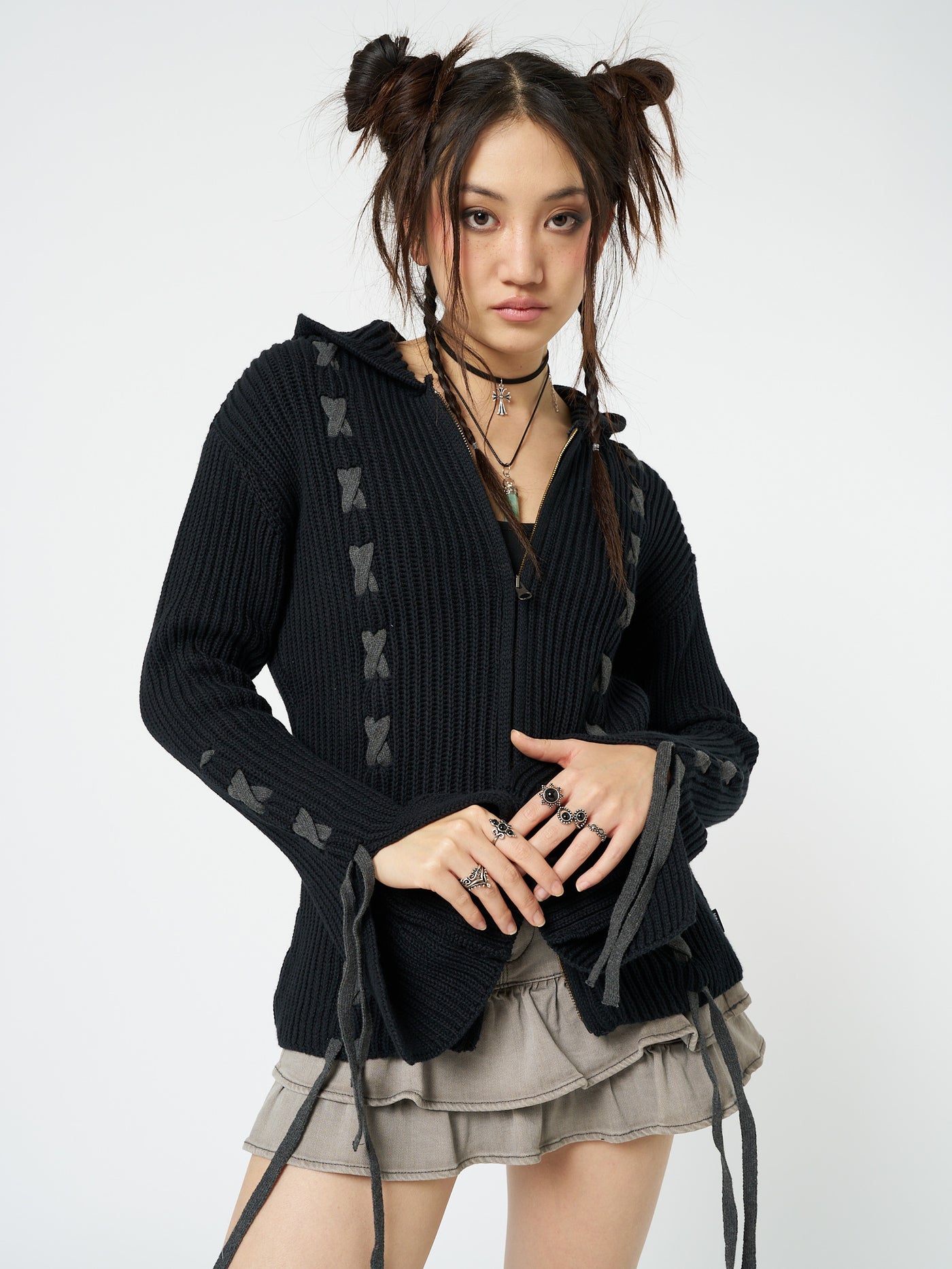 This black lace-up hoodie cardigan combines comfort and style effortlessly. The lace-up detailing adds a trendy touch to the classic hoodie design, making it a versatile and fashionable piece for any casual outfit.