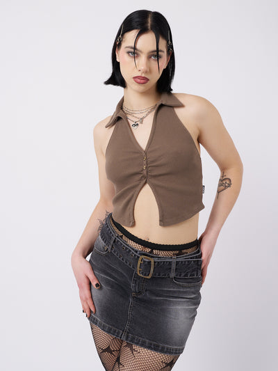 A taupe halter neck collar top named Raya by Minga London. This top features a unique and sophisticated design, with a halter neck and collar detail.