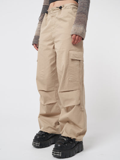 Beige tech cargo pants in parachute style with side utility pockets