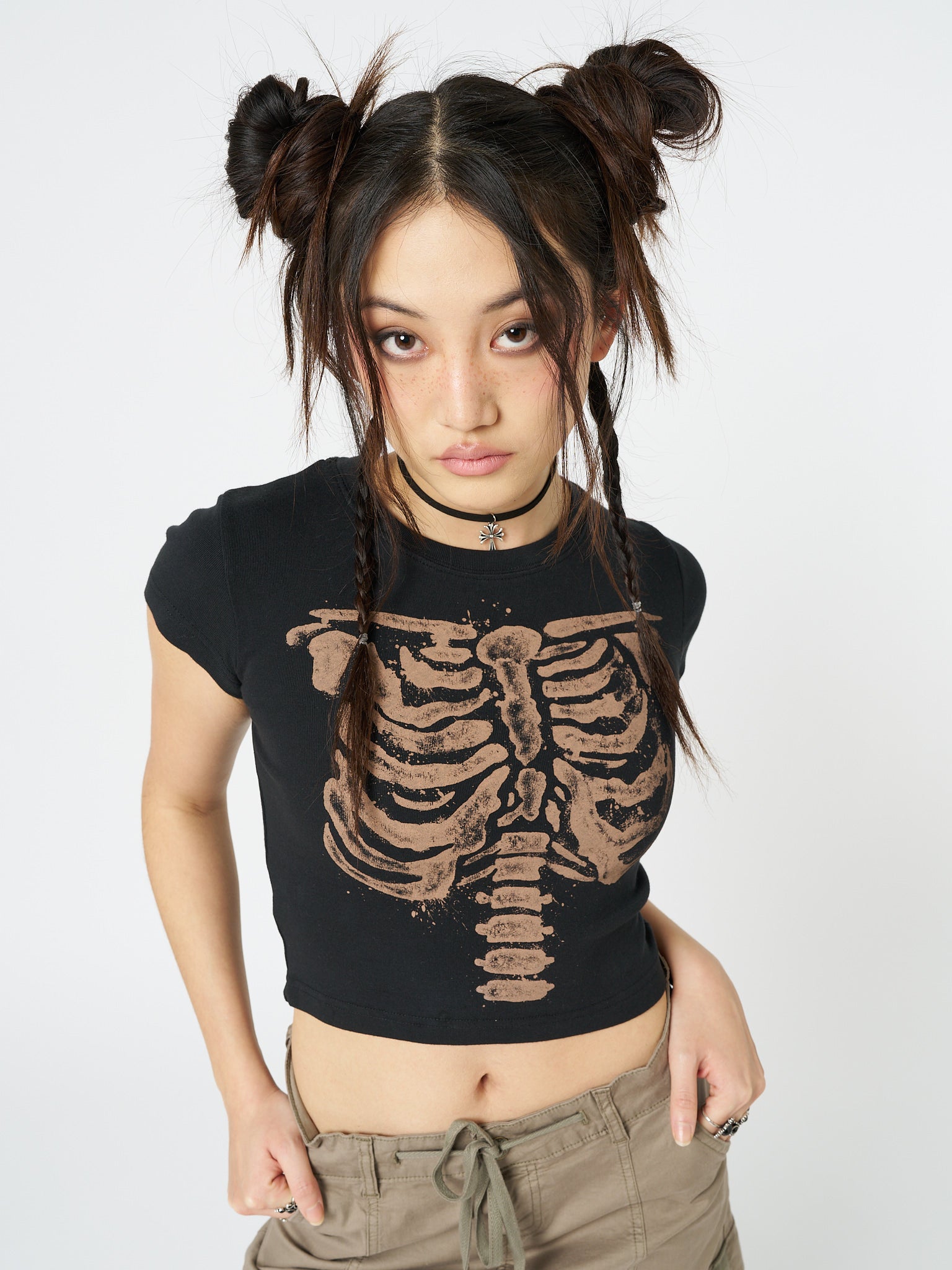 Embrace your edgy side with the Skeleton Black Graphic Print Baby Tee. This trendy baby tee features a striking skeleton graphic print, adding a cool and mysterious vibe to your outfit. Perfect for adding a touch of alternative style to your look.