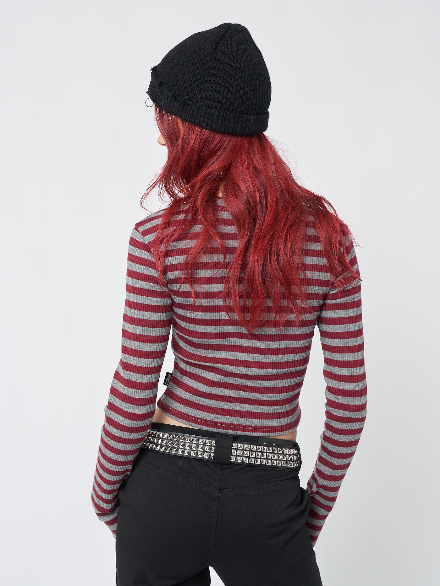 A trendy and stylish long-sleeved striped rib top in shades of grey and red, featuring star sign-inspired design.