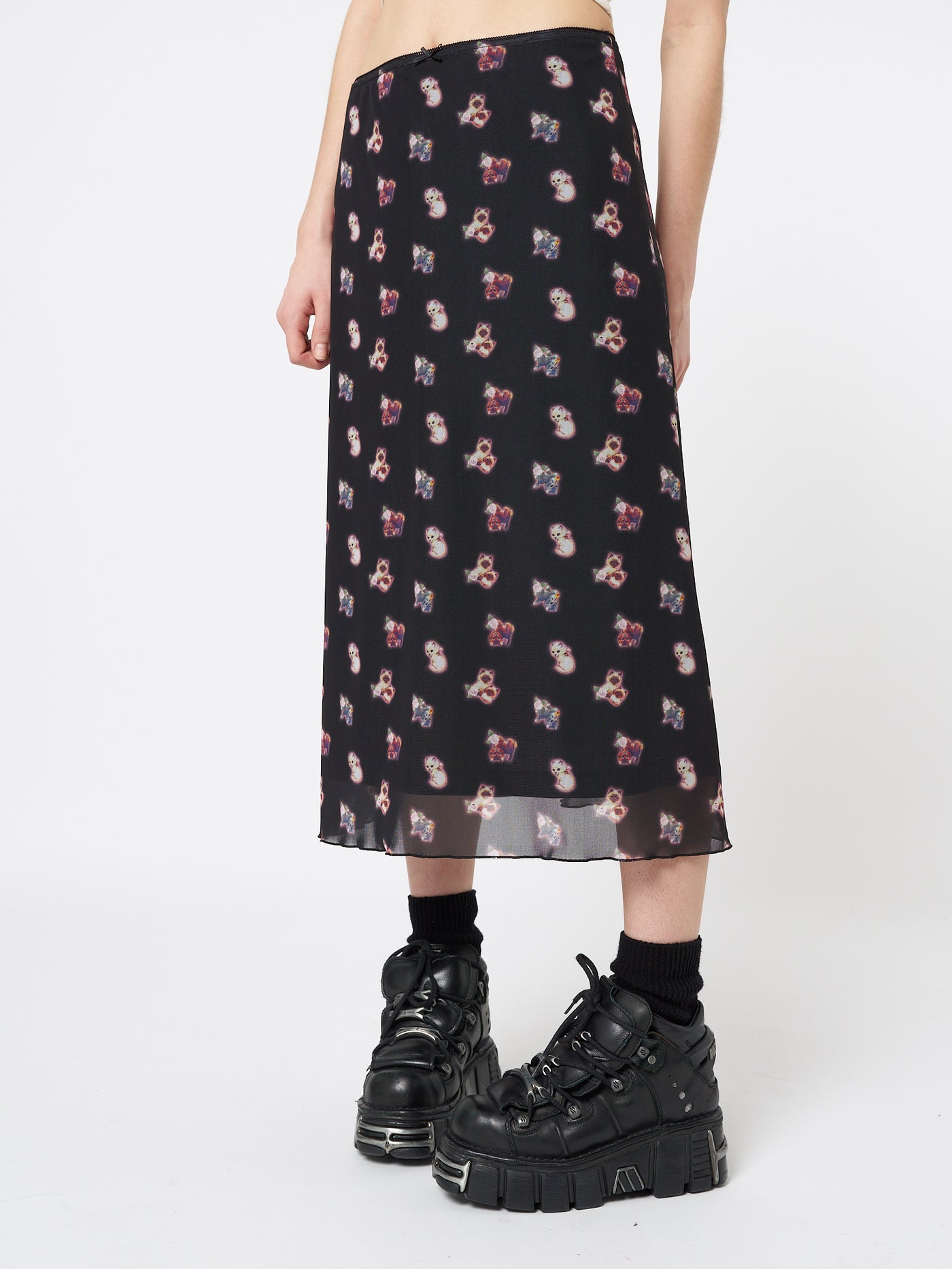 A midi mesh skirt named "That Cat Girl" by Minga London. This skirt showcases a playful and trendy design with its mesh fabric and cat-inspired motifs, adding a touch of fun and whimsy to your look.
