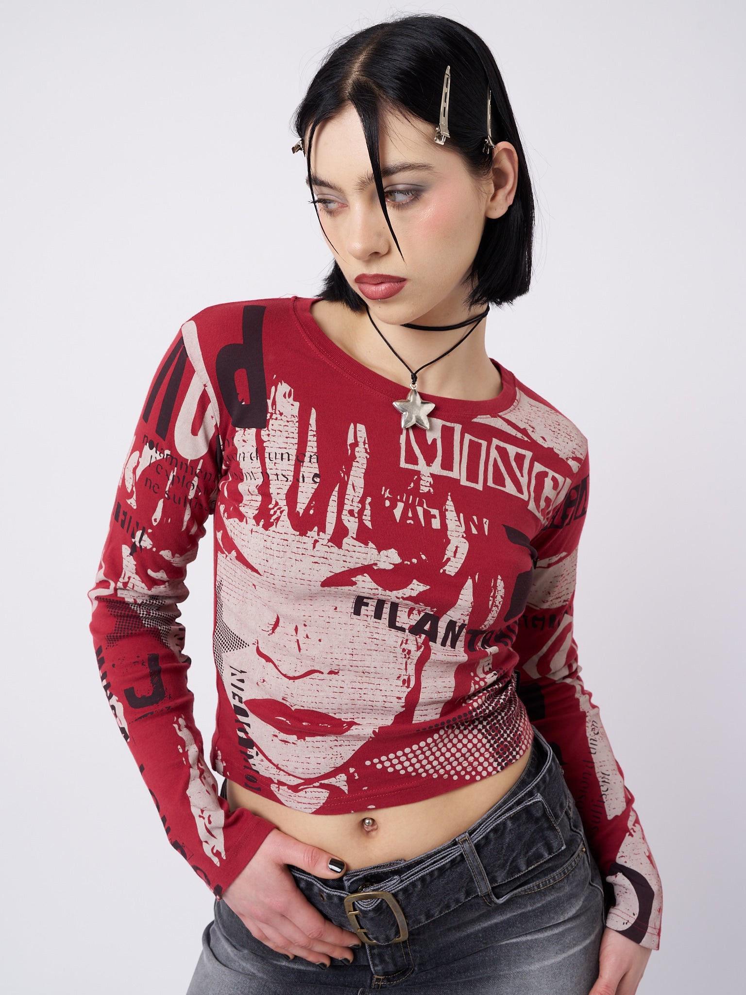 A red and black graphic top by Minga London. The top features a bold and eye-catching graphic design in contrasting colors. It has a comfortable fit and is made from high-quality materials. 