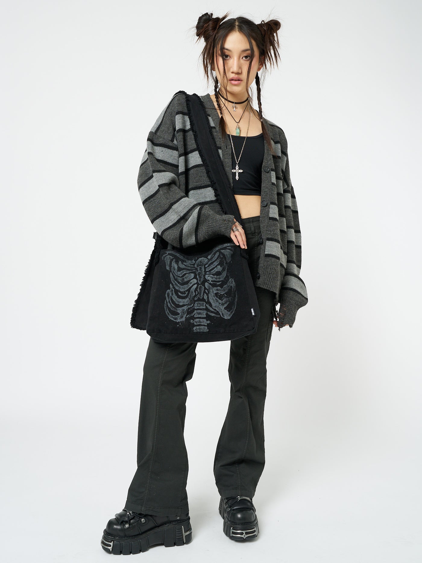 A shoulder strap bag with an X-ray skeleton design by Minga London. This unique bag features a striking and edgy print that adds a touch of alternative style to your outfit, making a bold statement wherever you go.